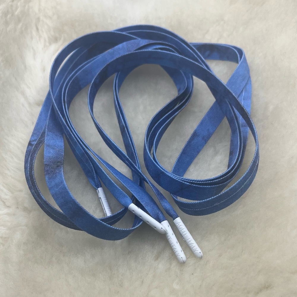A pair of tied-dyed shoelaces with matte-finished white tips